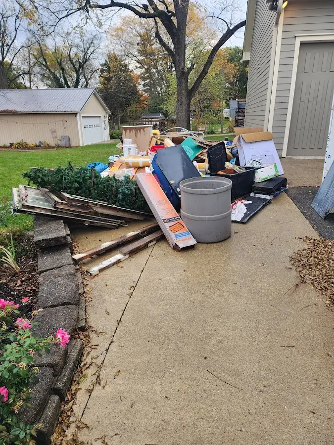 Dumpster being loaded with debris for Commercial Dumpster Rental in Carter Lake